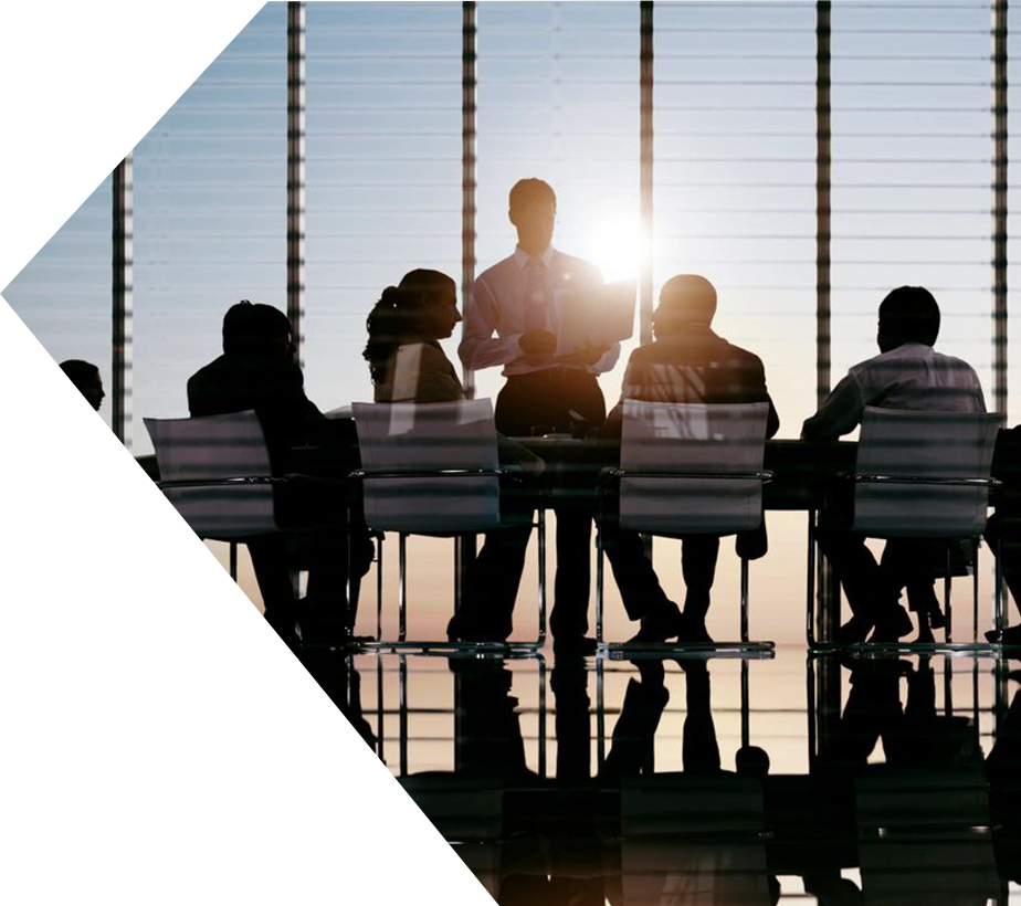 A group of people sitting at a table in front of a window.